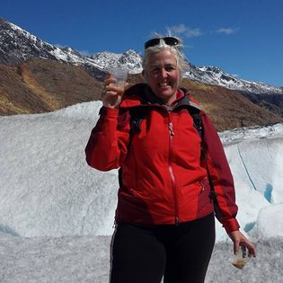 Jo toasting a drink on the side of a snow covered mountain